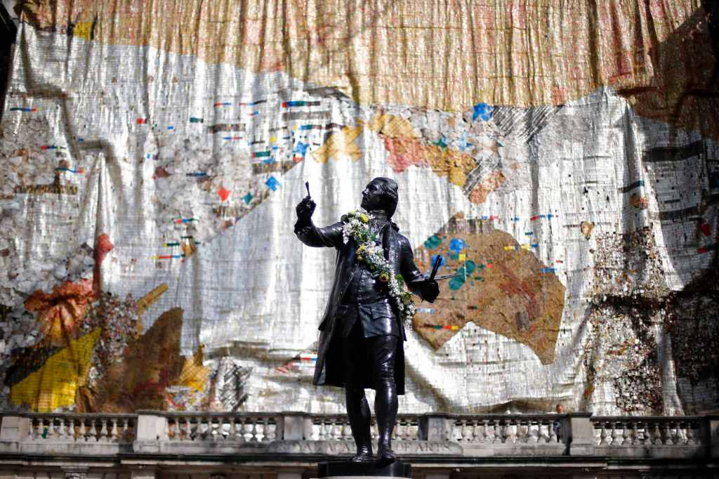 An El Anatsui "sculpture" hangs over the facade of the RA for this year's show